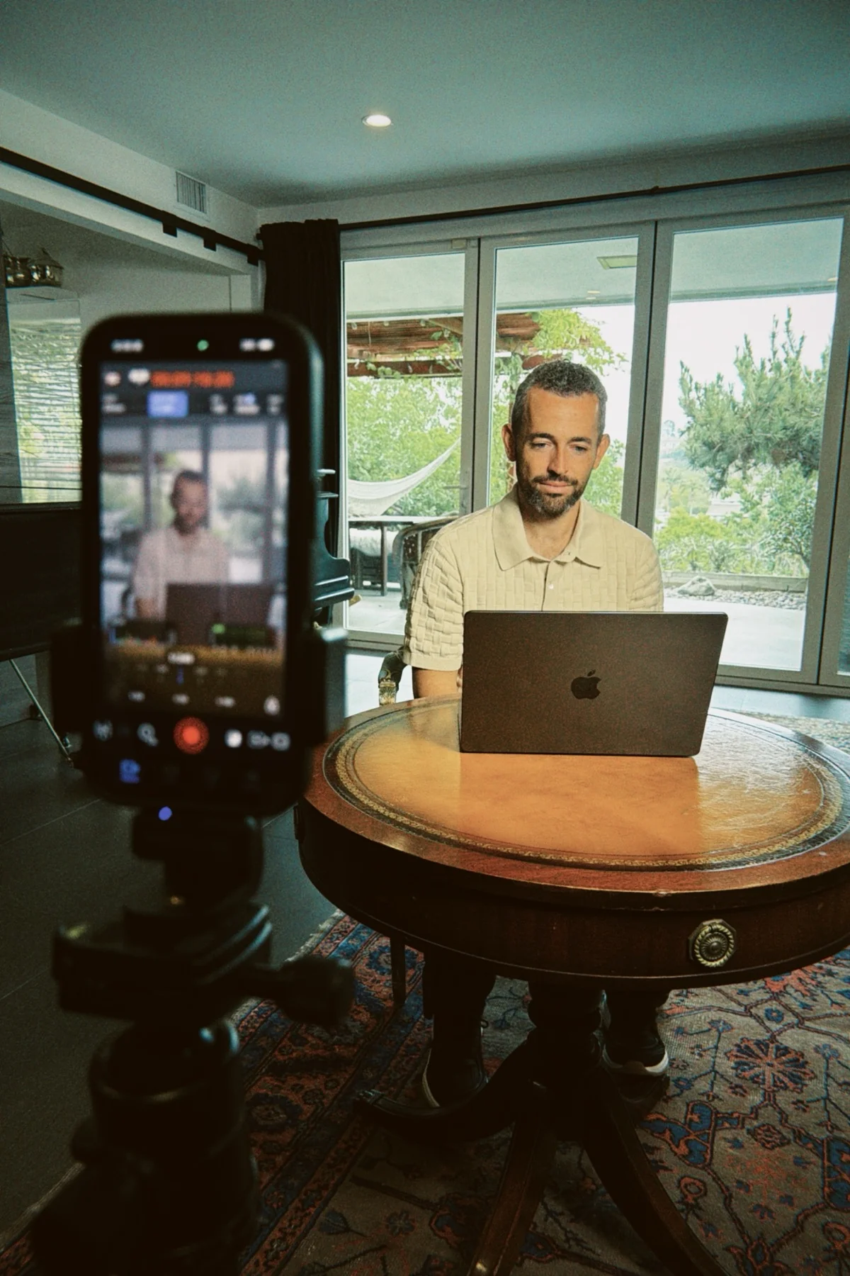 Behind the scenes on an Activate Talent shoot: Jared filmed on a phone rig while working at his laptop