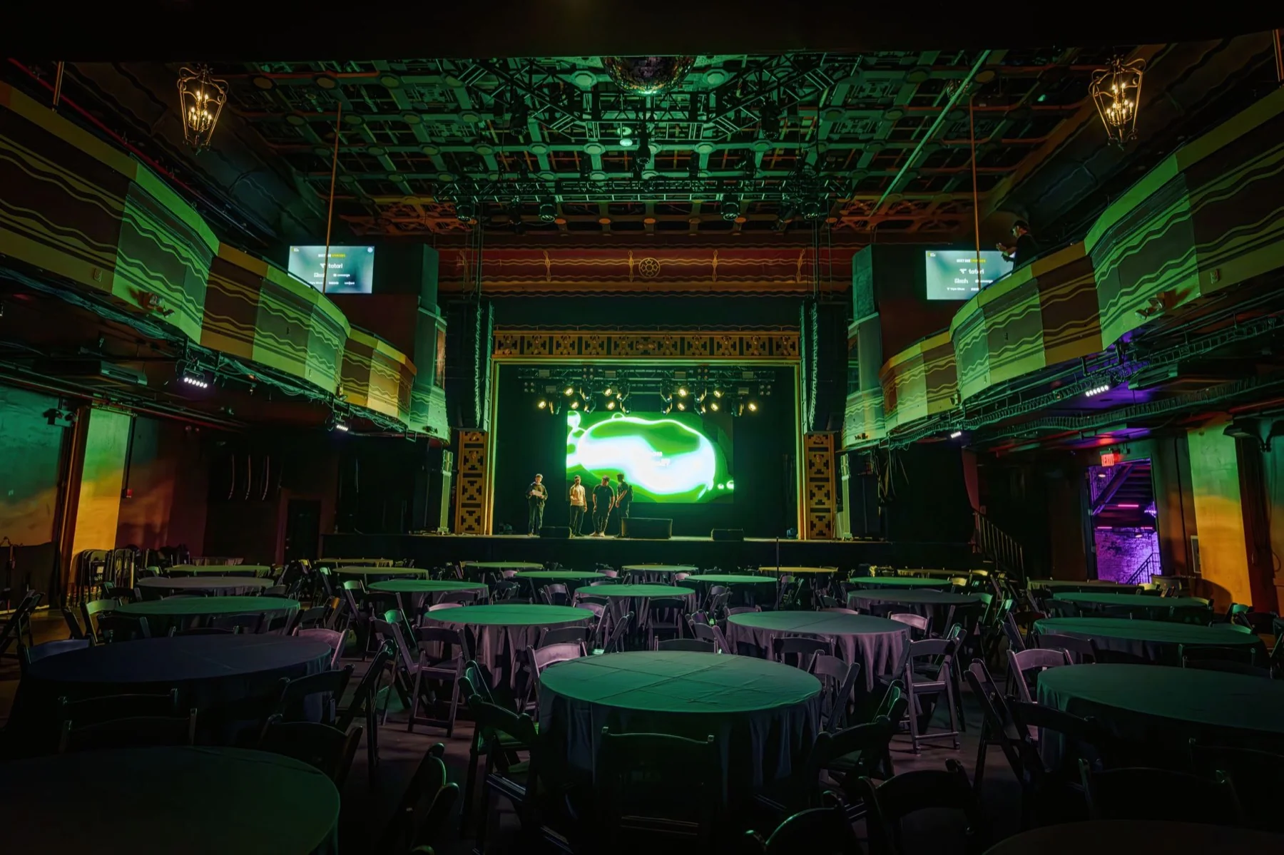 The AI Summit room at Webster Hall before doors, lit green, tables set in front of the stage